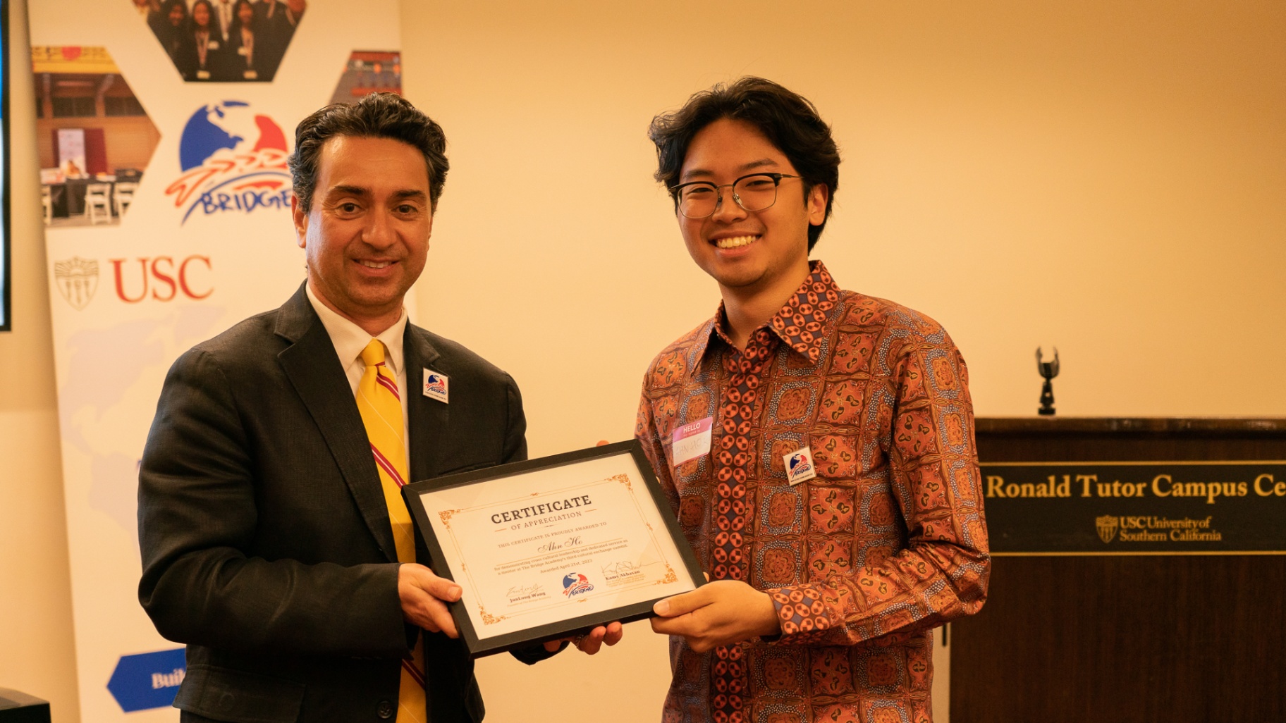 BCEA committee member receiving a certificate of appreciation from Kamy Akhavan