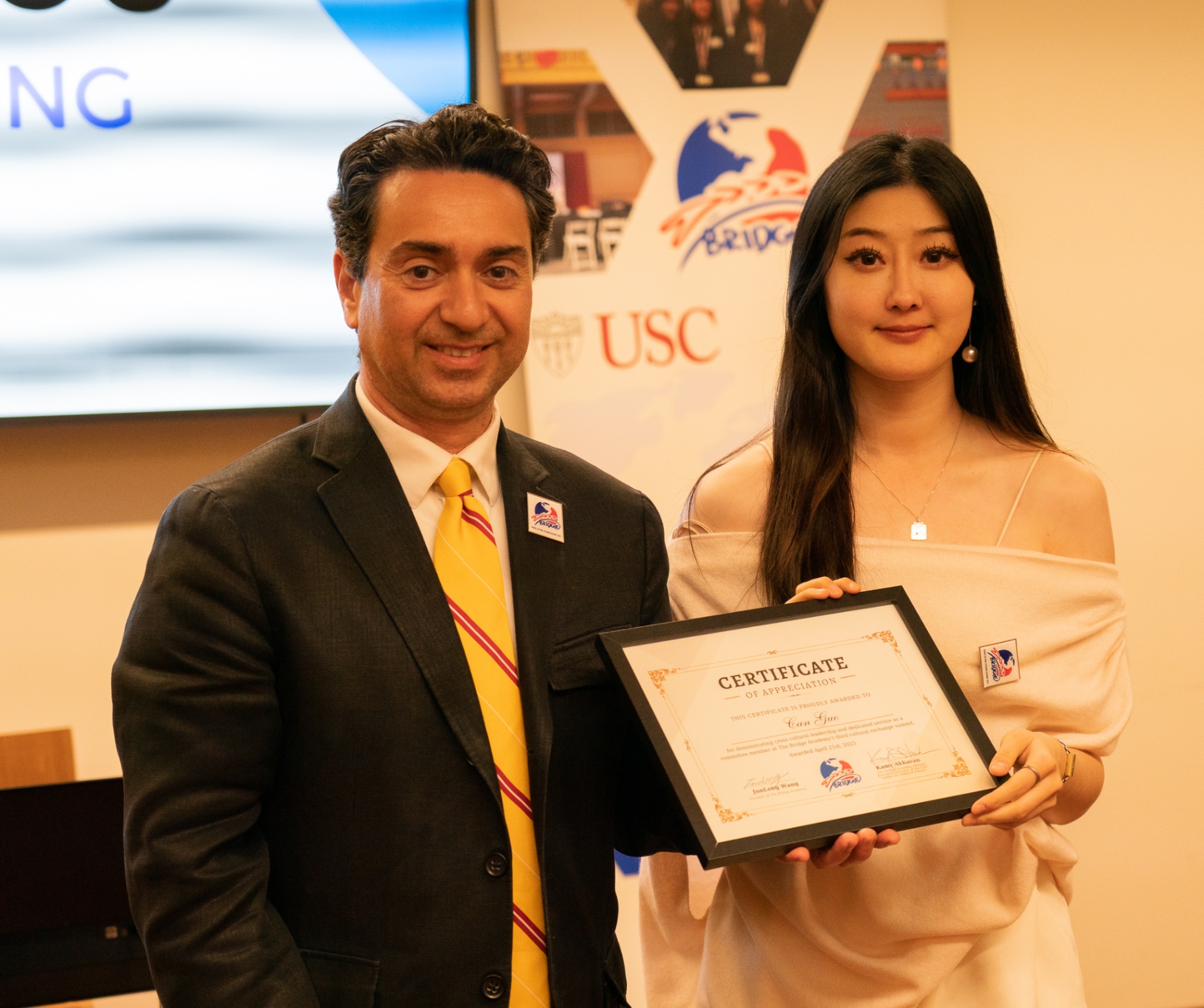 Kamy Akhavan presents a certificate of appreciation to a BCEA committee member
